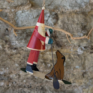 Tin Santa and Dog on a Paddleboard